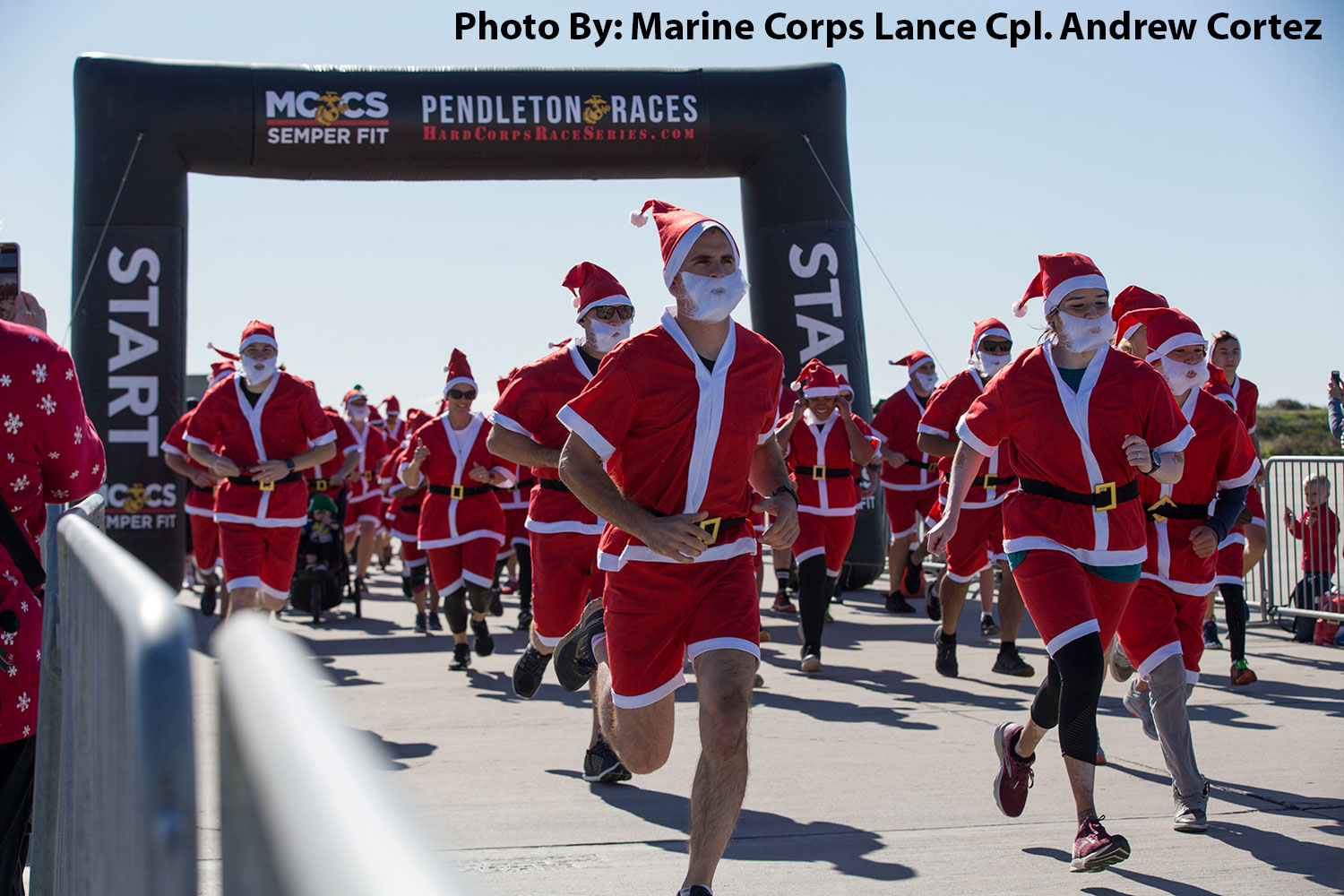 Camp Pendleton, California, December 15, 2019 -  Service members and their families sprint from the starting line during the Santa Run at Marine Corps Base Camp Pendleton.