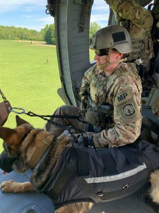 Sergeant Megan Hurley and Military Working Dog Bill from the 510th Military Police Detachment (MWD), 716th Military Police Battalion, 101st Sustainment Brigade, prepare to fast rope out of a UH-60 Blackhawk Helicopter during pre-deployment training. From providing unique patrol, explosives and narcotic detection capabilities through law enforcement on Fort Campbell, Kentucky to deploying into combat zones such as Iraq and Afghanistan, the 510th MP DET is staying busy. (U.S. Army photo by: 1st Lt. M. Austin Giles, 510th Military Police Detachment (MWD), 716th Military Police Battalion) (Photo Credit: Courtesy)