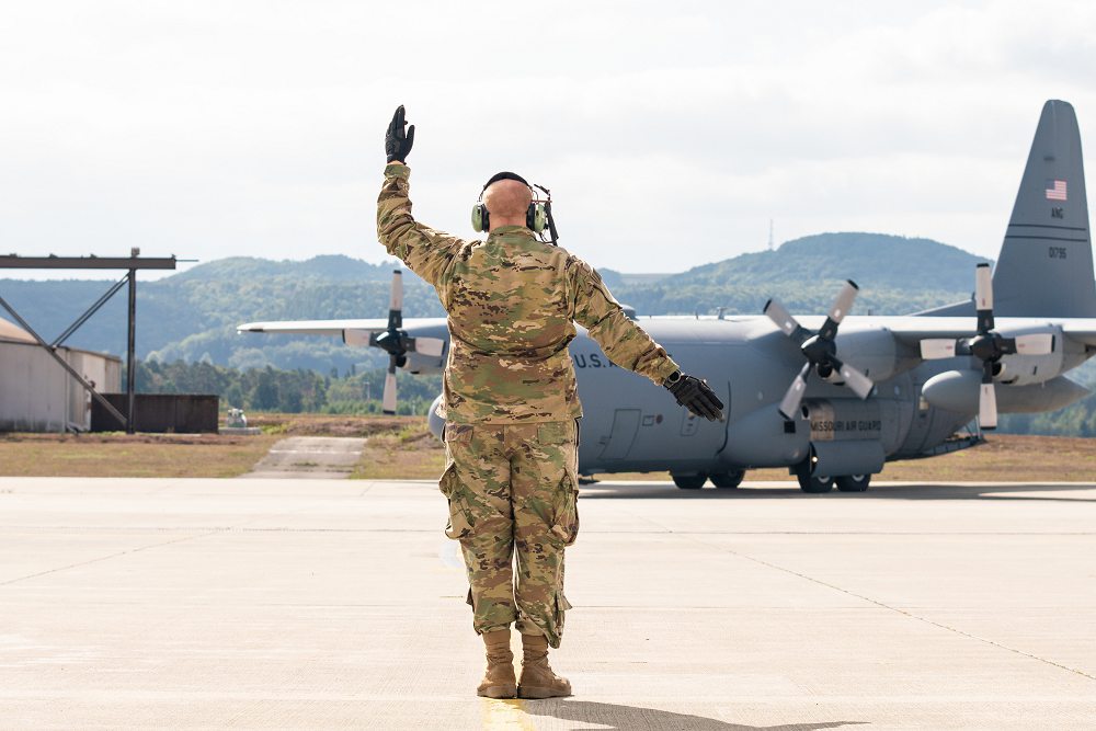 U.S. Air Force Tech. Sgt. Jonathan Jones, with the 139th Airlift Wing, Missouri Air National Guard, marshals in a C-130H Hercules aircraft during Saber Junction 19 at Ramstein Air Base, Germany, Sep. 17, 2019. SJ19 is an exercise involving 16 allies and partner nations at the U.S. Army’s Grafenwoehr and Hohenfels Training Areas, Sept. 3-30. (Photo by Tech. Sgt. Patrick Evenson)