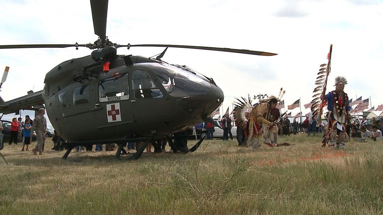 Two members of the Standing Rock Sioux Nation dance in traditional attire around a South Dakota Army National Guard UH-72 Lakota helicopter after a blessing ceremony for the aircraft on June 10, 2012. South Dakota Photo by Sgt. Jacqueline Fitzgerald