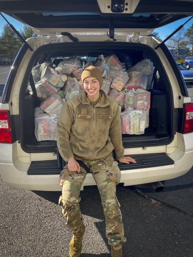 Senior Airman Alexis Maher, 103rd Security Forces Squadron defender, packs a vehicle with Thanksgiving meal kits at Bradley Air National Guard Base in East Granby, Connecticut, Nov. 16, 2020. Maher organized the squadron’s second annual Thanksgiving food drive, in which 103rd Airlift Wing members helped donate a total of 120 family meal kits to food banks in six Connecticut towns. (Courtesy photo)