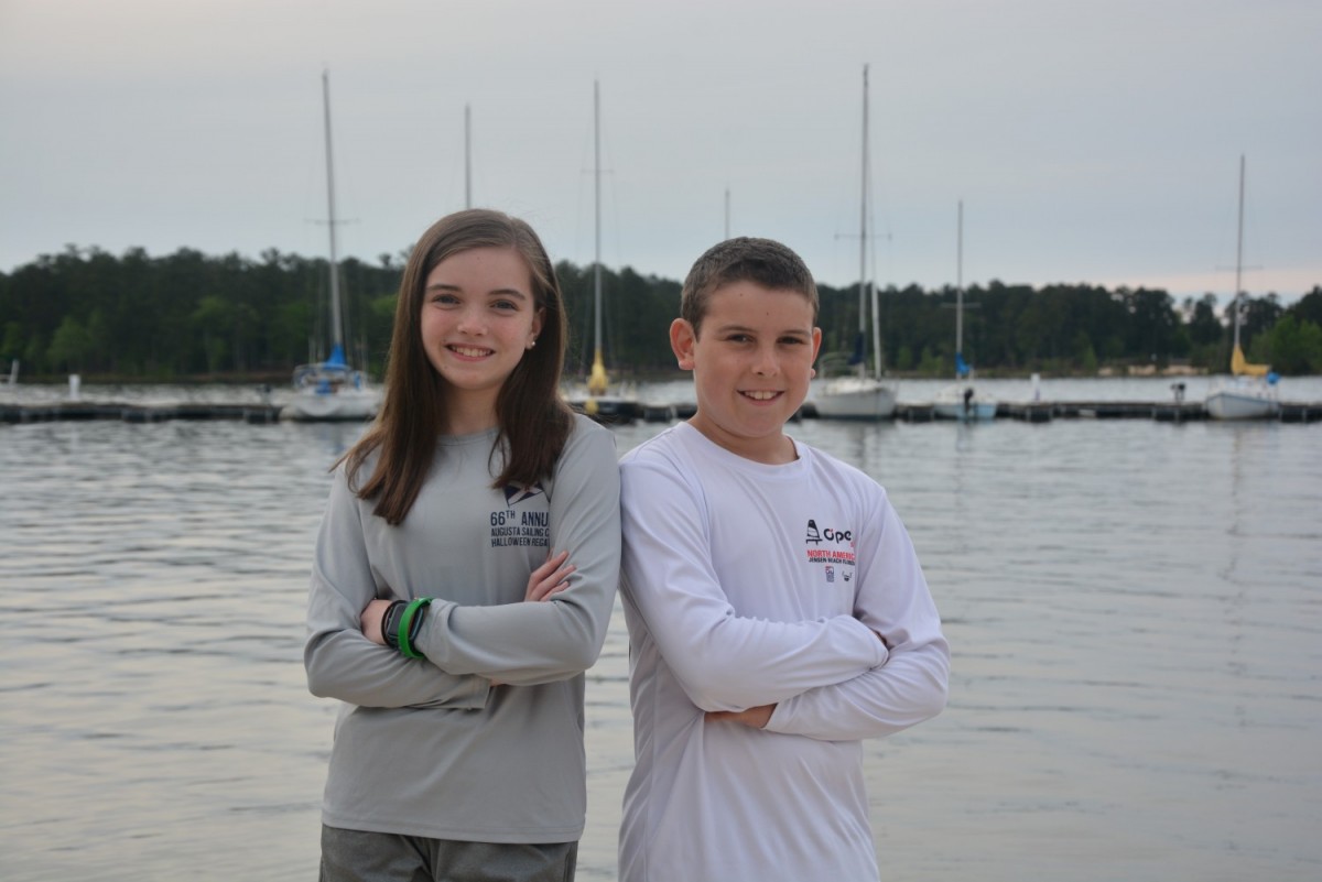 Katelyn and Grant Jr. Dietert, of Evans, pose for a photo at Clarks Hill Lake where the duo house their sailboats. The siblings seized an opportunity to enroll in a summer sailing camp two years ago through the Augusta Sailing Club and have grown to love the sport. Sailing is one of many activities they said they would not have thought to try if it wasn't for being part of the military family. (Laura Levering / Fort Gordon Public Affairs )