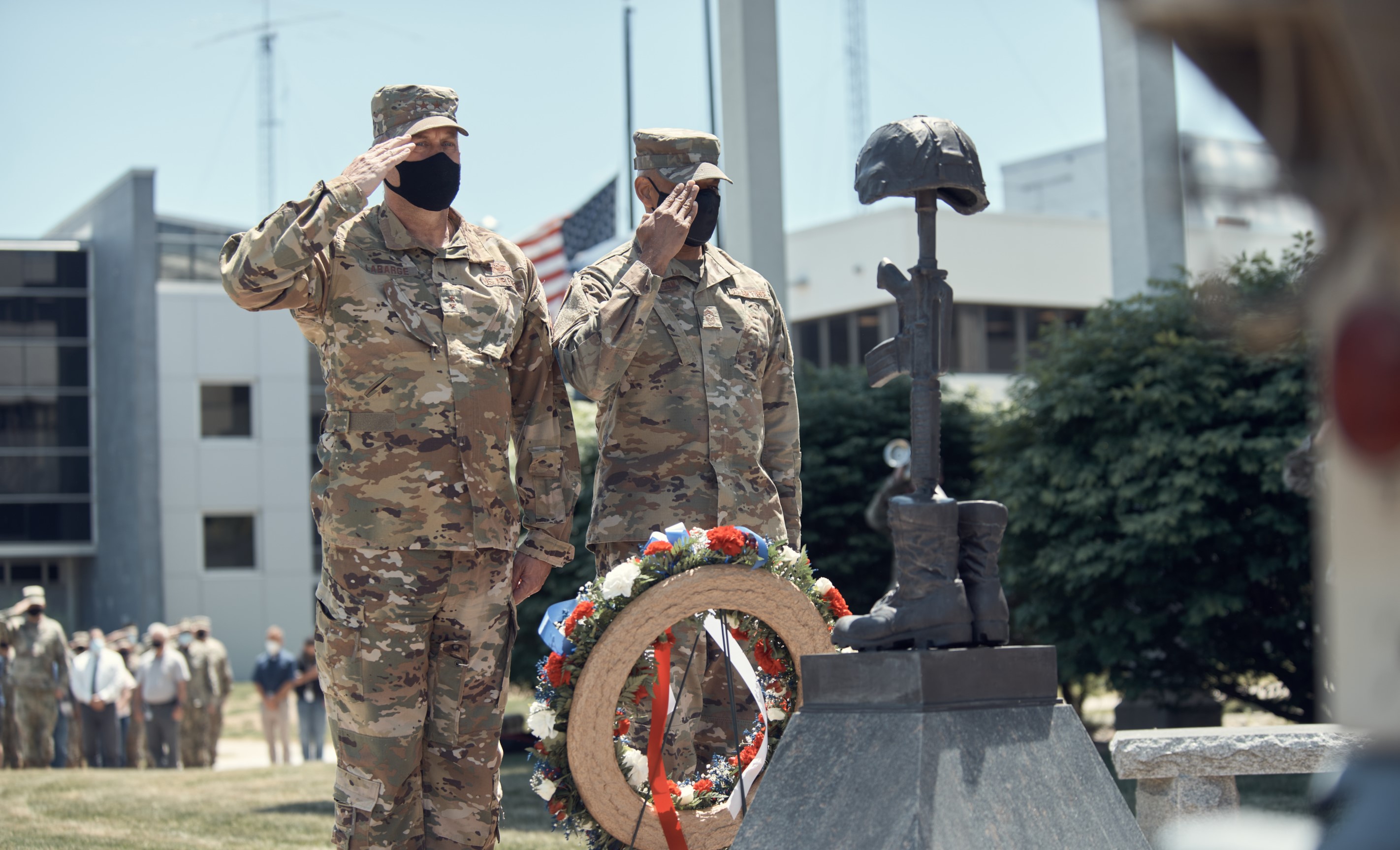 LATHAM, N.Y. - Air Force Maj. Gen. Timothy LaBarge, assistant adjutant general for New York, and Air Force Command Chief Master Sgt. Denny Richardson, state command chief for New York, render honors while taps is played during a Memorial Day service in Latham, N.Y., May 27, 2021. Each year the facility holds a service to recognize New York Guardsman who died the previous year.