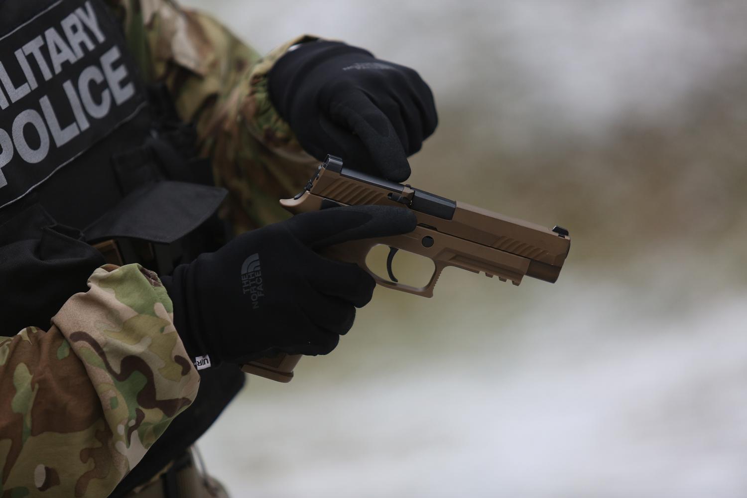 HOHENFELS, Germany - 1st Lt. Anna Kretzer, a platoon leader assigned to the 527th Military Police Company, qualifies on the new M17. The U.S. Army started fielding Military Police units with the new SIG Sauer M17 pistol to replace the M9 Beretta.  Photo by Sgt. Tristin Maximilian