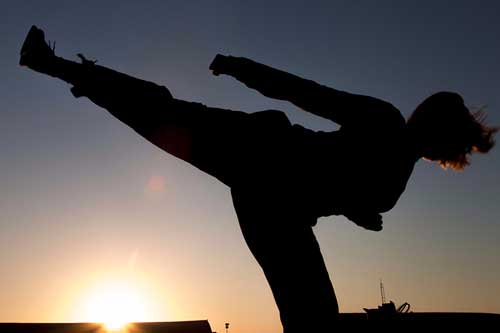 California Army National Guard Sgt. Cassandra Peel, an avionics mechanic in Bravo Company, 640th Aviation Support Battalion, 40th Combat Aviation Brigade, practices taekwondo kicks at Camp Buehring, Kuwait, April 2, 2016. Peel has practiced taekwondo for six years and is now a second degree black belt. Army photo by Staff Sgt. Ian Kummer