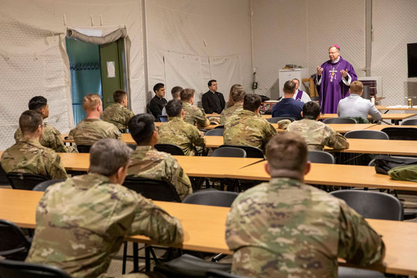 PABRADE, LITHUANIA, April 12, 2022 -   U.S. Army Soldiers with 3rd Battalion, 66th Armored Regiment, 1st Armored Brigade Combat Team, 1st Infantry Division, attend Catholic mass hosted by Lithuanian Archbishop Gintaras Grušas, at Camp Herkus, Lithuania, April 12, 2022. Photo by Sgt. Brandon Bruer.