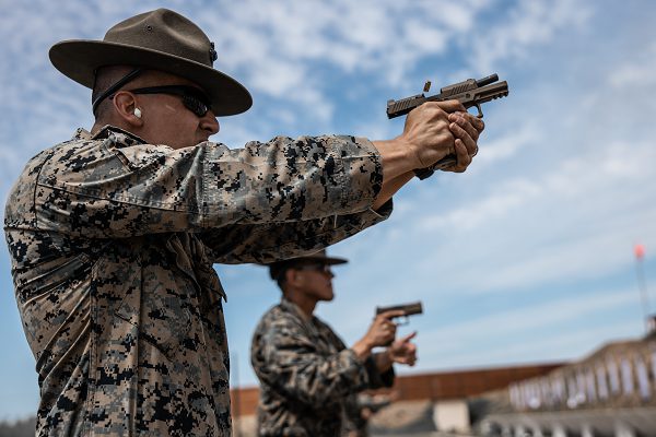 In this photo by Corporal Anthony Pio, Staff Sergeant Marco Casillas, an instructor for the Formal Marksmanship Training Center, Weapons and Field Training Battalion, demonstrates a drill during Combat Pistol training.